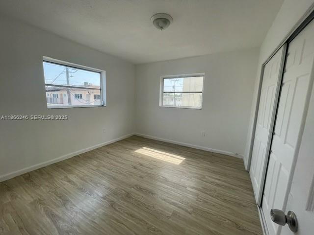1735 Northeast 164th Street, Unit F204 North Miami Beach, FL 33162 - Photo 11 of 25 a view of empty room with wooden floor and fan