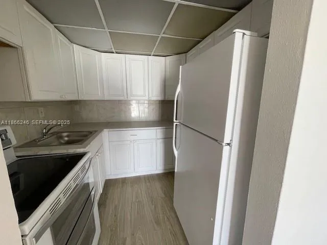 a kitchen with stainless steel appliances a refrigerator and a stove