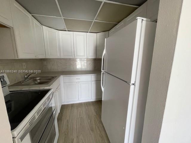 1735 Northeast 164th Street, Unit F204 North Miami Beach, FL 33162 - Photo 14 of 25 a kitchen with stainless steel appliances a refrigerator and a stove