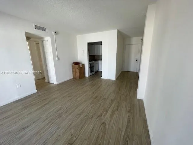an empty room with wooden floor and closet