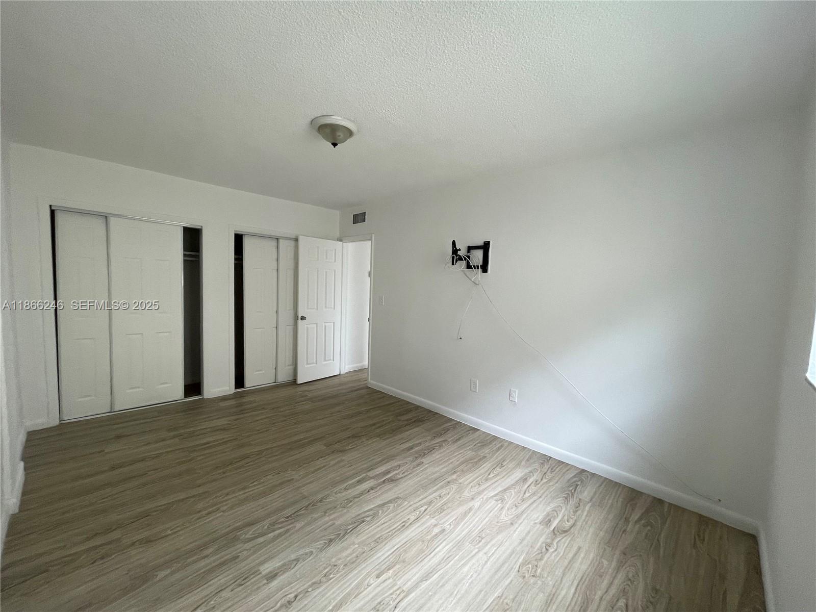1735 Northeast 164th Street, Unit F204 North Miami Beach, FL 33162 - Photo 2 of 25 a view of an empty room with wooden floor