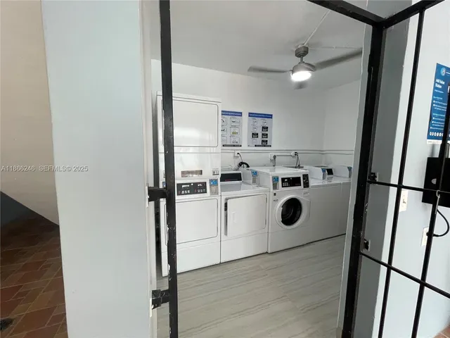 a view of washer and dryer with wooden floor