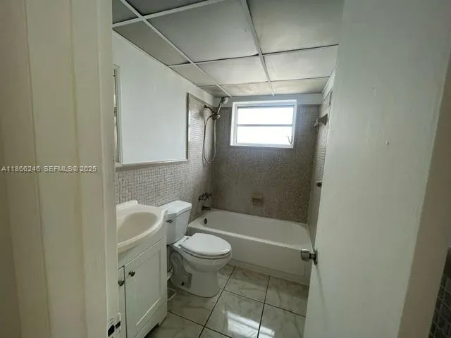 a bathroom with a toilet a sink and shower