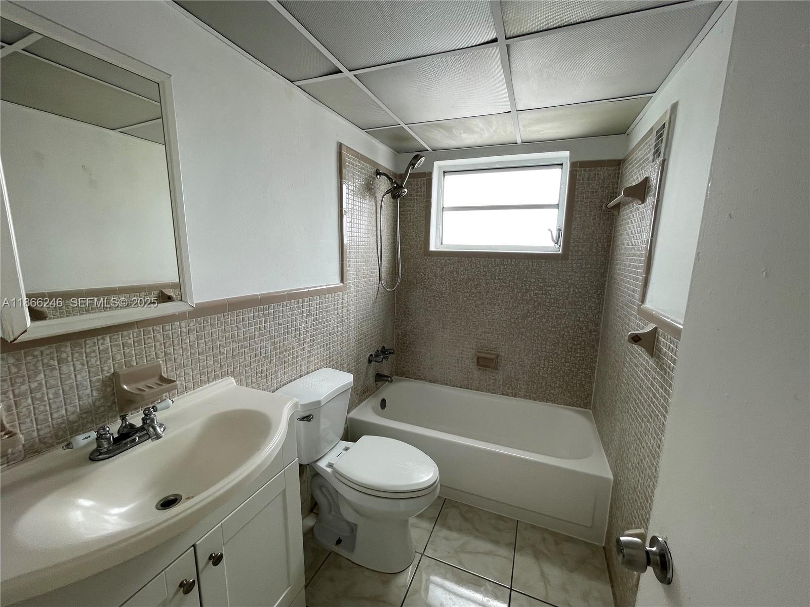 1735 Northeast 164th Street, Unit F204 North Miami Beach, FL 33162 - Photo 7 of 25 a bathroom with a sink toilet and shower