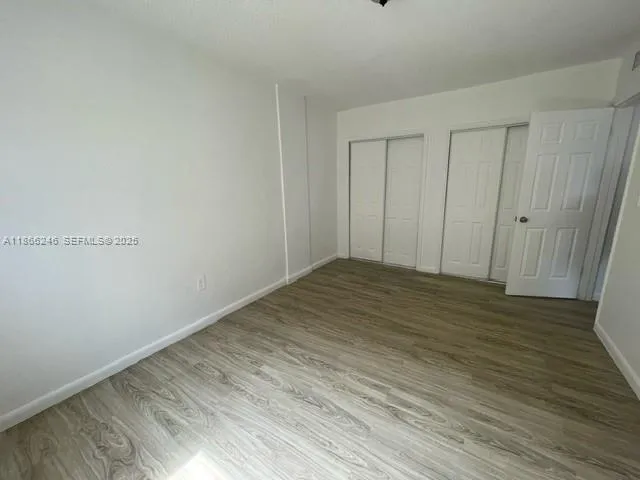 a view of a room with wooden floor