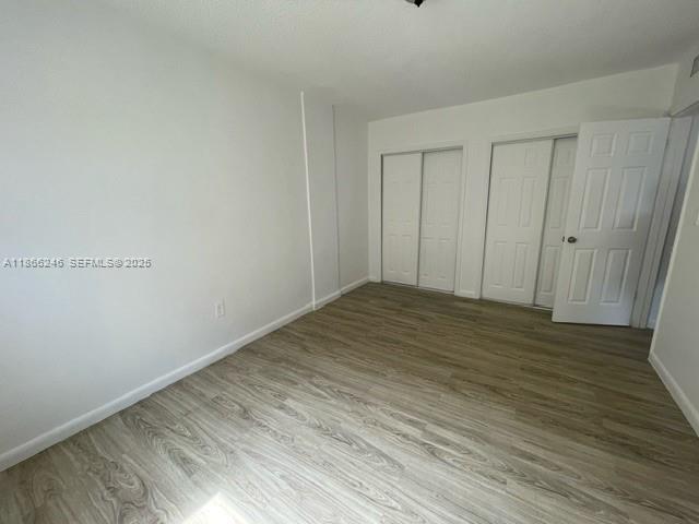 1735 Northeast 164th Street, Unit F204 North Miami Beach, FL 33162 - Photo 9 of 25 a view of a room with wooden floor