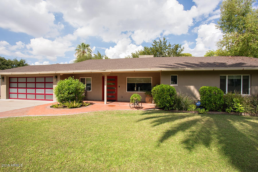 130 East Lawrence Road Phoenix, AZ 85012 - Photo 1 of 18 a front view of a house with a big yard and potted plants