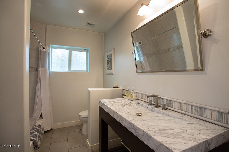 130 East Lawrence Road Phoenix, AZ 85012 - Photo 14 of 18 a bathroom with a sink a toilet and mirror
