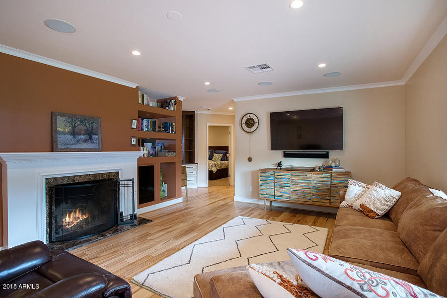130 East Lawrence Road Phoenix, AZ 85012 - Photo 2 of 18 a living room with furniture and a flat screen tv