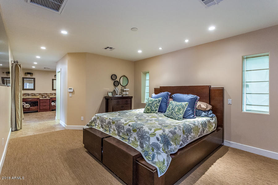 130 East Lawrence Road Phoenix, AZ 85012 - Photo 8 of 18 a bedroom with a large bed and a couch