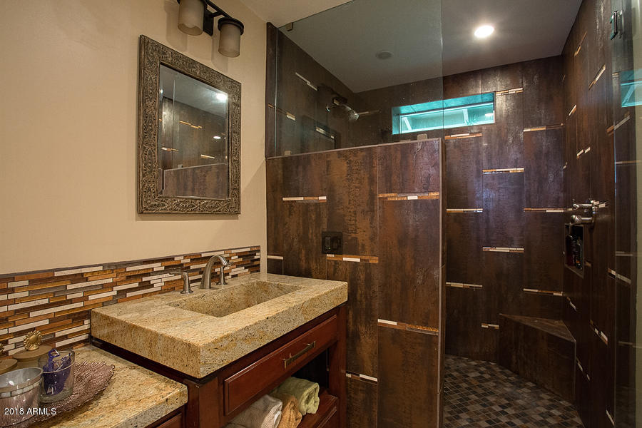 130 East Lawrence Road Phoenix, AZ 85012 - Photo 10 of 18 a bathroom with a sink mirror and shower