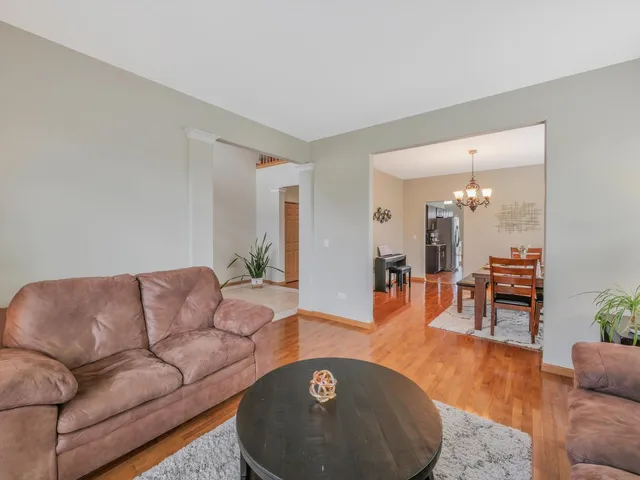 a view of a dining room with furniture wooden floor and chandelier