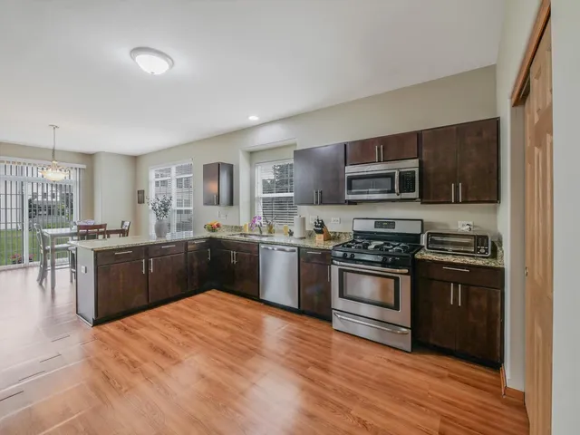 a view of a dining room with furniture wooden floor and a chandelier