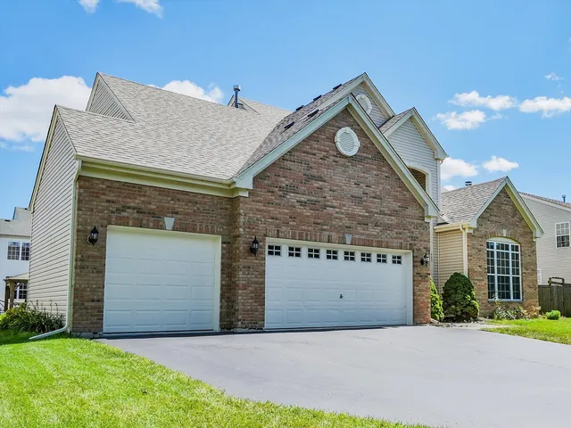a front view of a house with a yard and garage