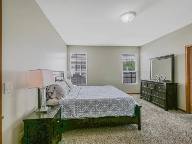 a spacious bedroom with a bed and a couch