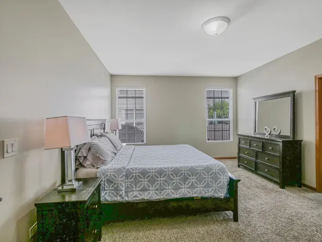 a bedroom with a bed and a dresser