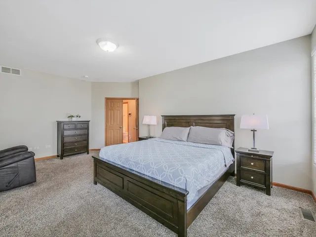 a bathroom with a granite countertop sink a toilet and shower