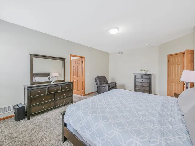 a bathroom with a granite countertop sink a large mirror and a bathtub