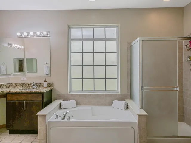 a spacious bathroom with a granite countertop sink and a mirror