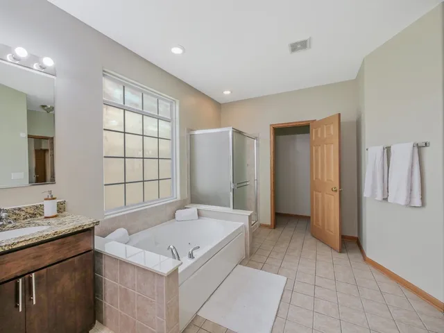 a white toilet sitting next to a white wall