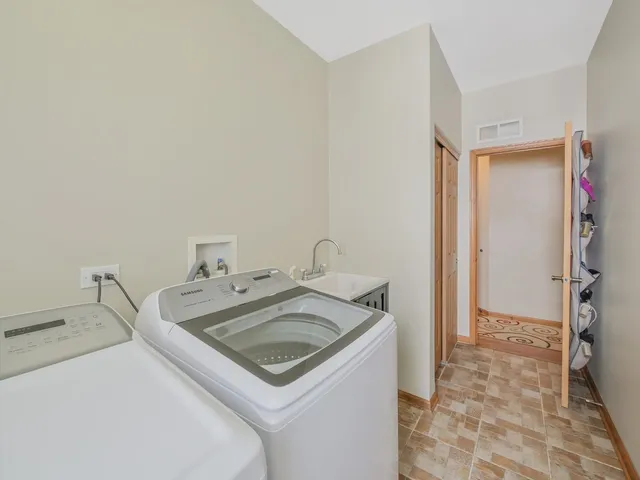 a view of a bedroom with baby crib and toys