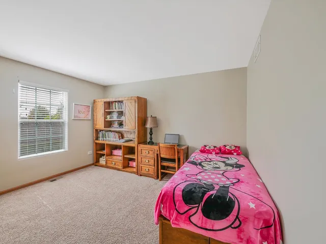 a bedroom with a bed and with furniture