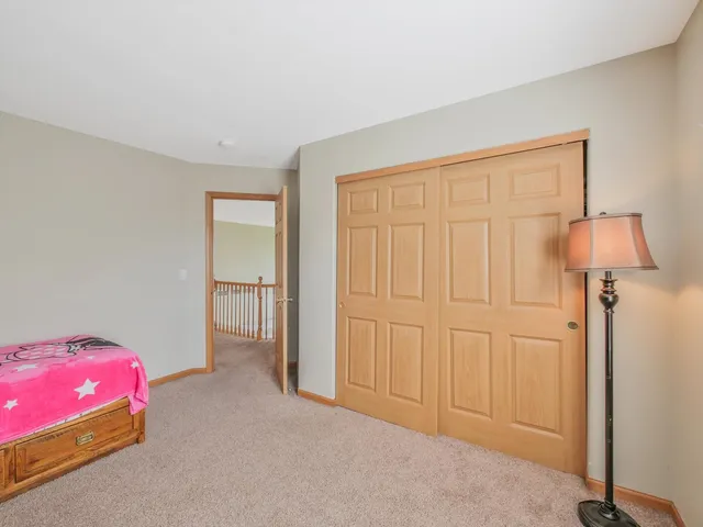 a bedroom with a large bed and a closet