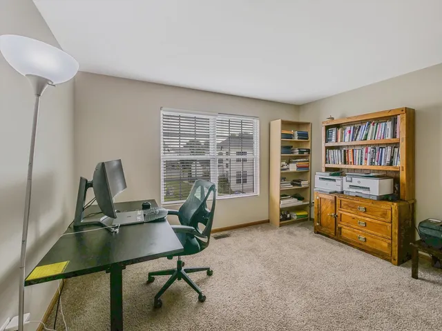 a view of empty room with wooden ceiling