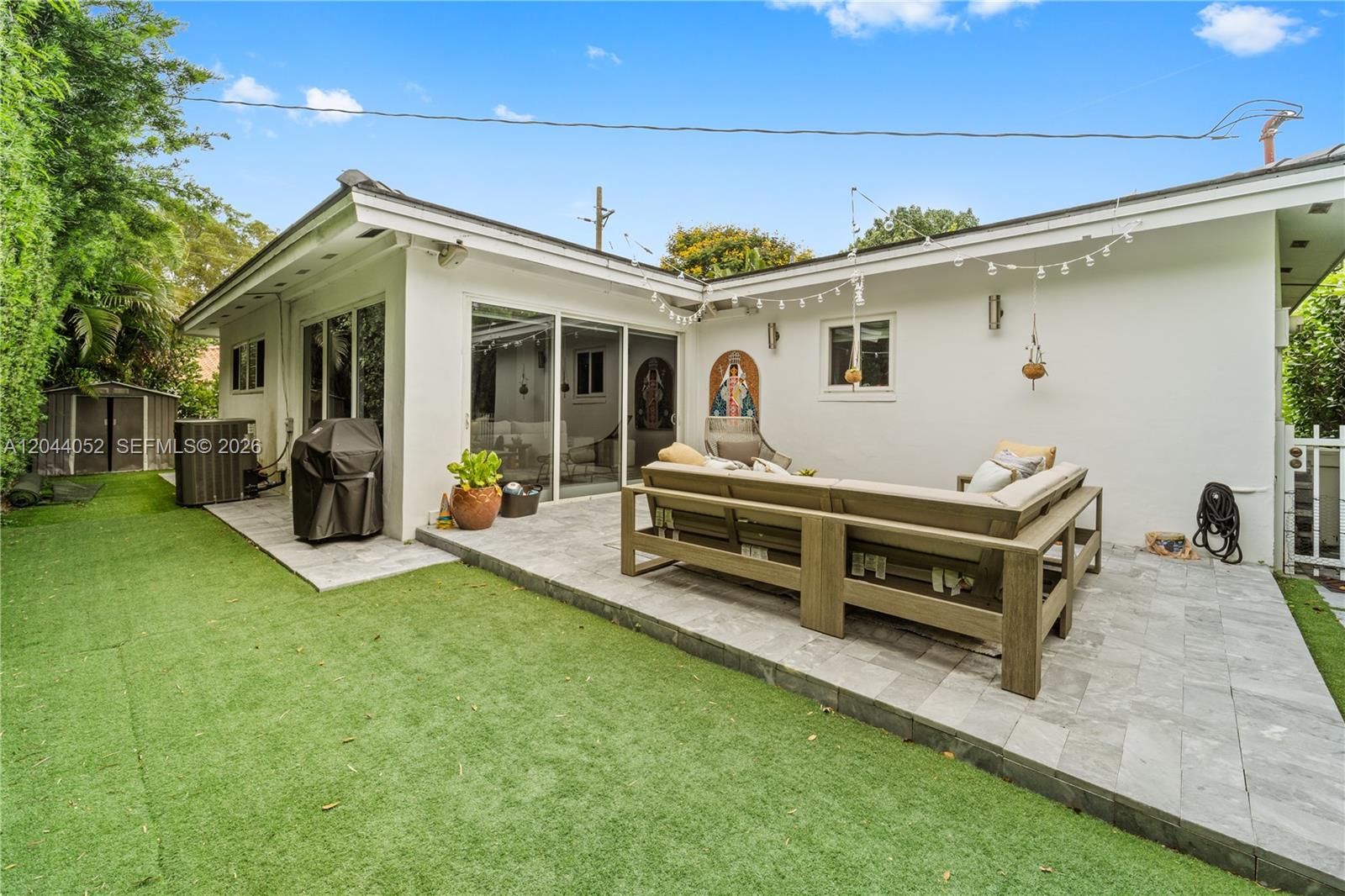 721 Bird Road Coral Gables, FL 33146 - Photo 18 of 24 a view of a house with a flat tv screen couches and a table