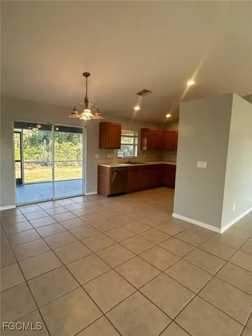 a large kitchen with dining table and a large window