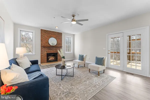 a kitchen with stainless steel appliances a stove a sink dishwasher a refrigerator and cabinets with wooden floor