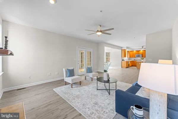a dining room with furniture a chandelier and wooden floor