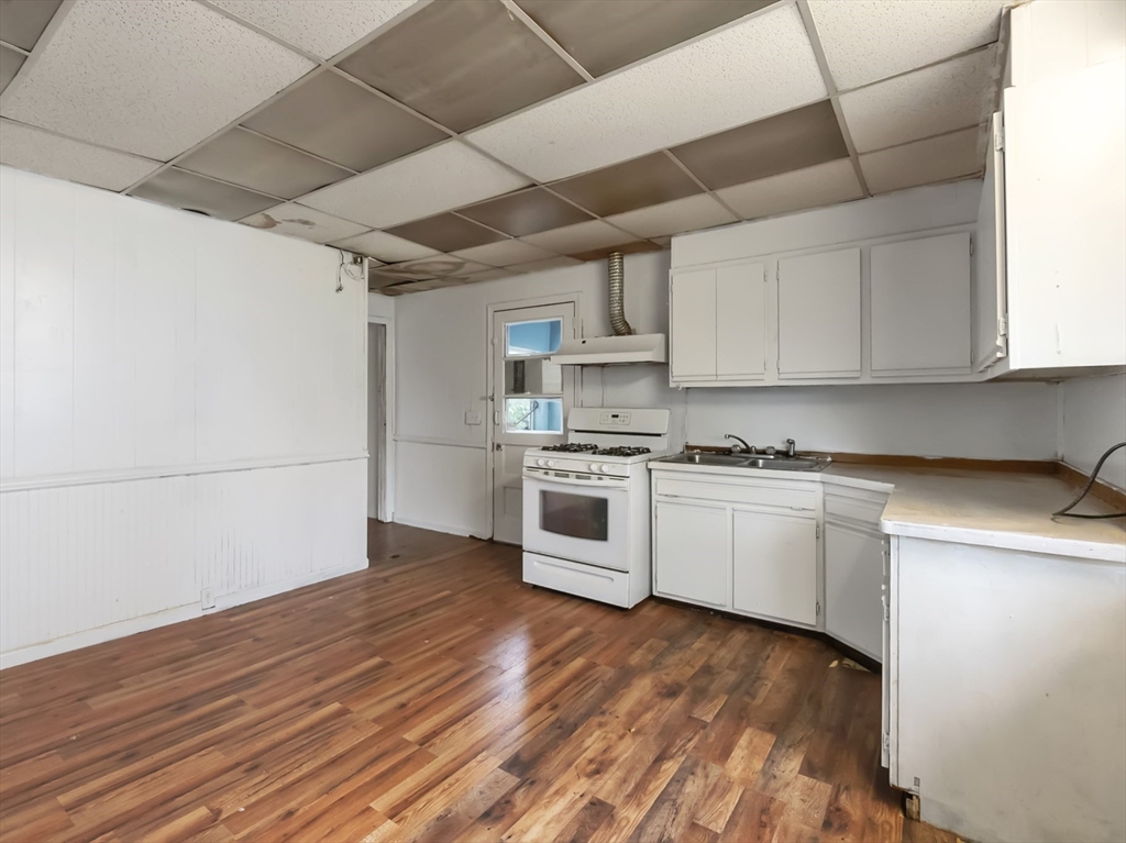 234 Allen Street Springfield, MA 01108 - Photo 14 of 14 a kitchen with granite countertop white cabinets and white appliances