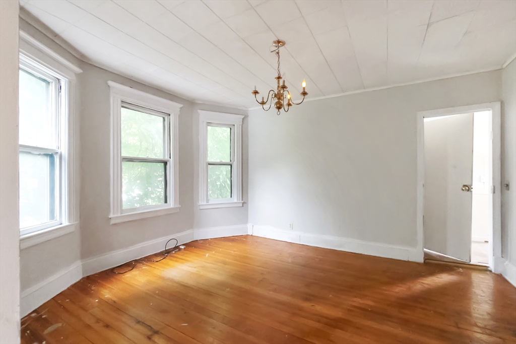 234 Allen Street Springfield, MA 01108 - Photo 3 of 14 a view of empty room with wooden floor and fan