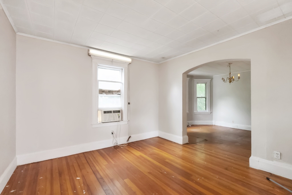 234 Allen Street Springfield, MA 01108 - Photo 4 of 14 an empty room with wooden floor and windows