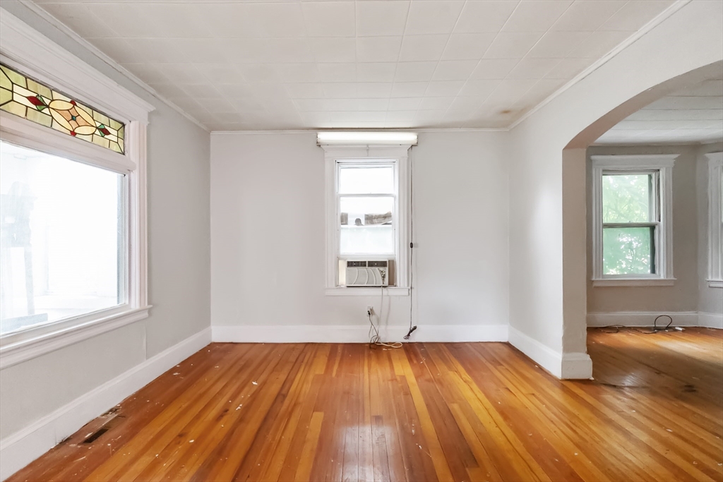 234 Allen Street Springfield, MA 01108 - Photo 5 of 14 an empty room with wooden floor and windows