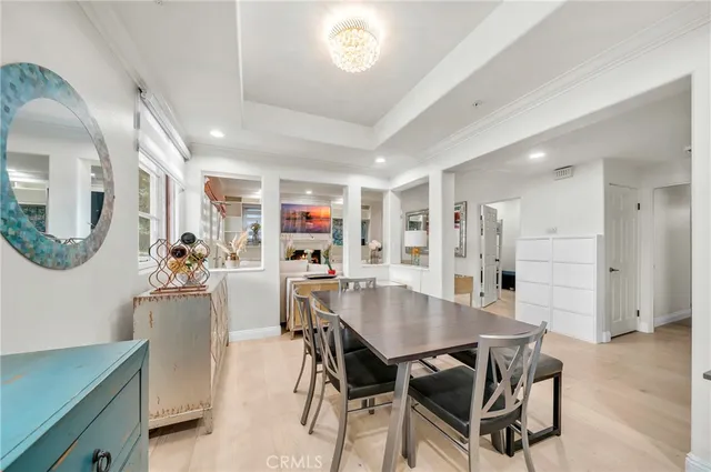a living room with furniture a large window and wooden floor