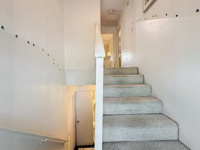 a view of staircase with white walls