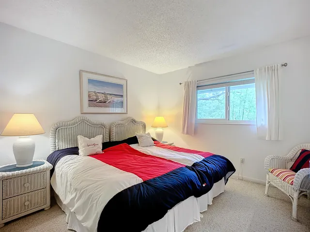 a bedroom with bed and a window