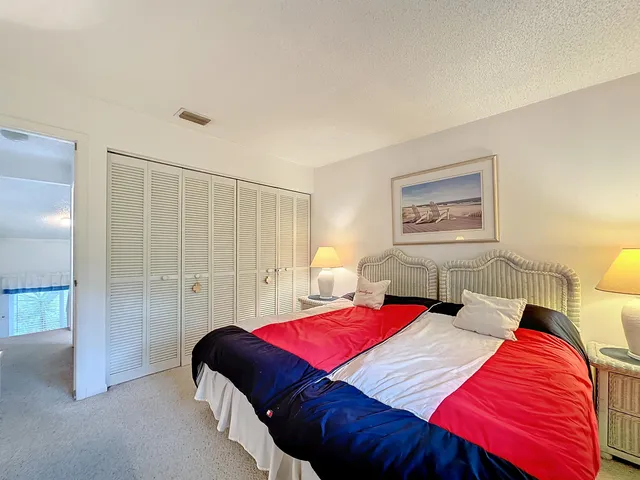 a bedroom with a bed and a lamp