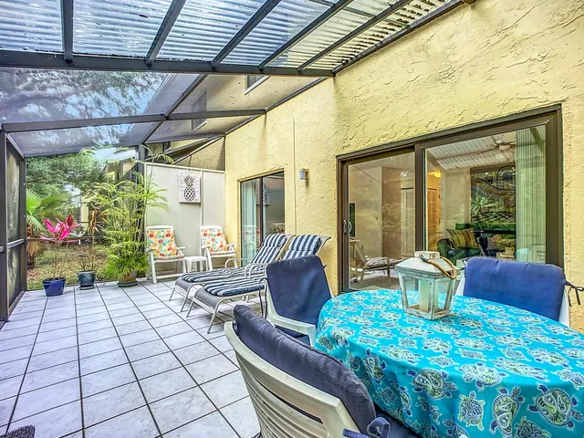 a balcony with furniture and a potted plant