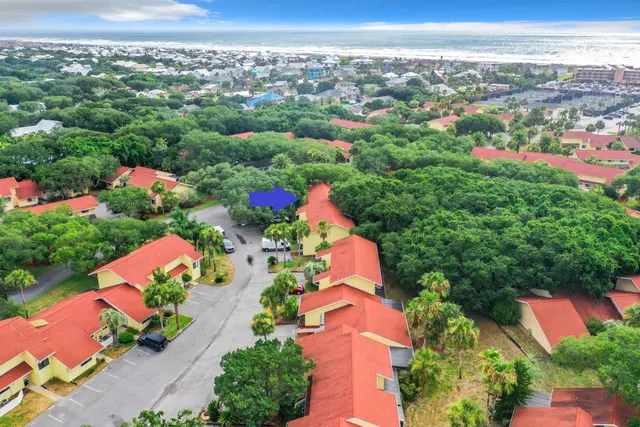 an aerial view of lake and residential houses with outdoor space