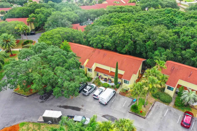 an aerial view of a house with garden space and street view