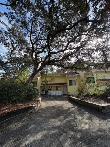 a front view of a house with a yard and a garage
