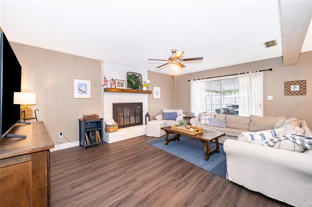 2464 Hunterfield Road Maitland, FL 32751 - Photo 14 of 26 a living room with furniture and a fireplace