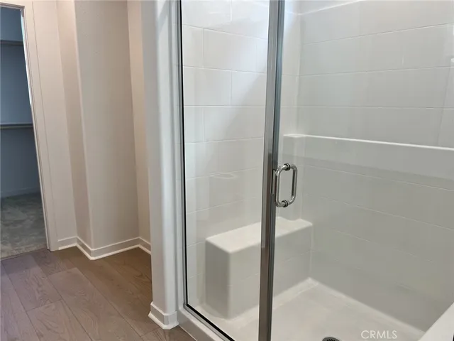 a bathroom with a glass shower door