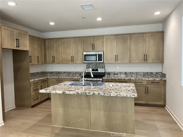 a kitchen with a stove a sink and a refrigerator