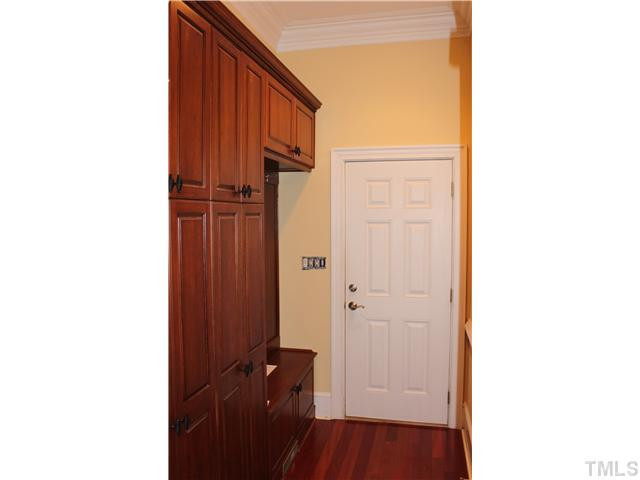 2108 Tulare Court Raleigh, NC 27612 - Photo 10 of 25 Mudroom with seat and cloths hooks cherry cabinets with black basket pulls Other