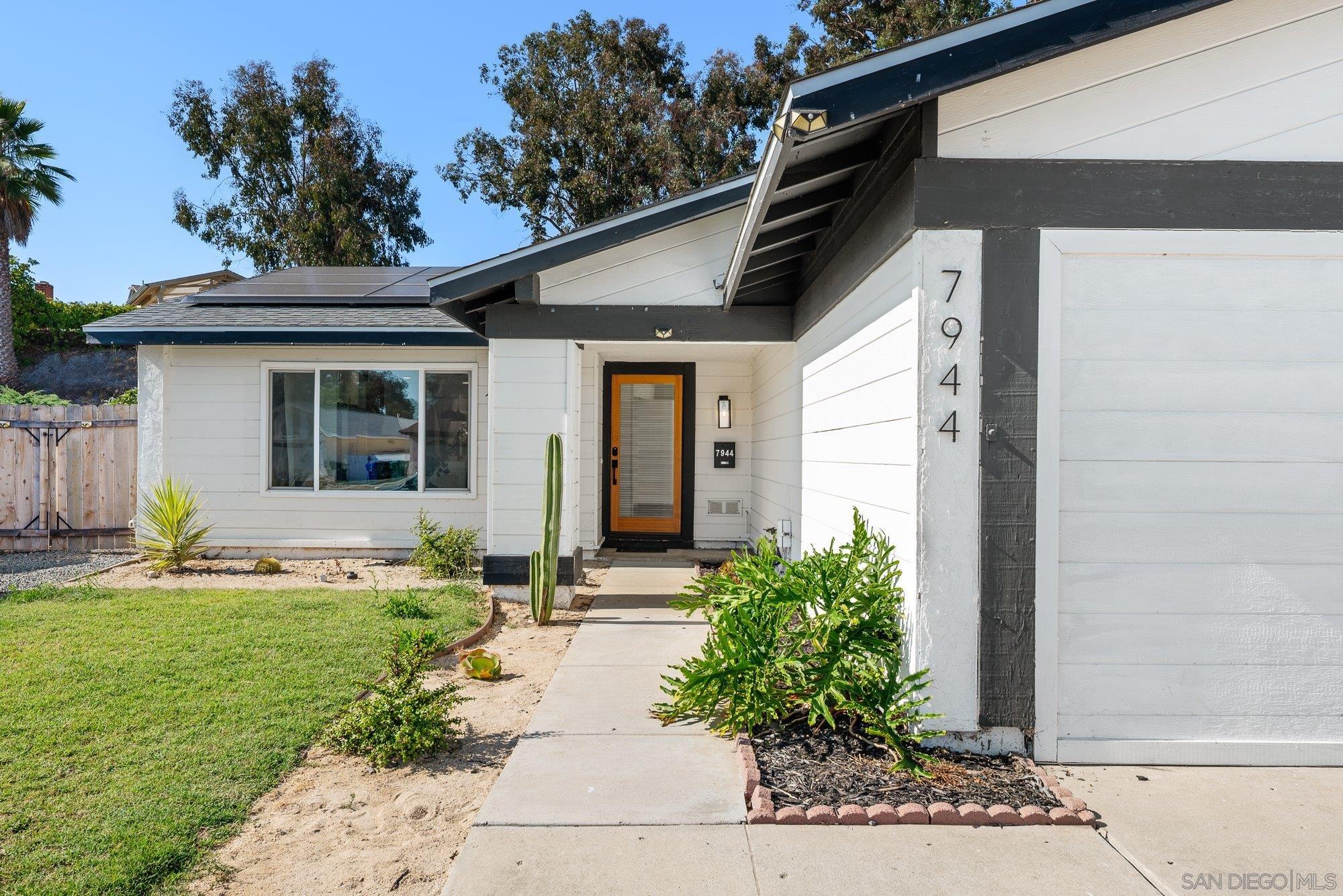 7942 Calico Street San Diego, CA 92126 - Photo 2 of 39 a front view of a house with garden