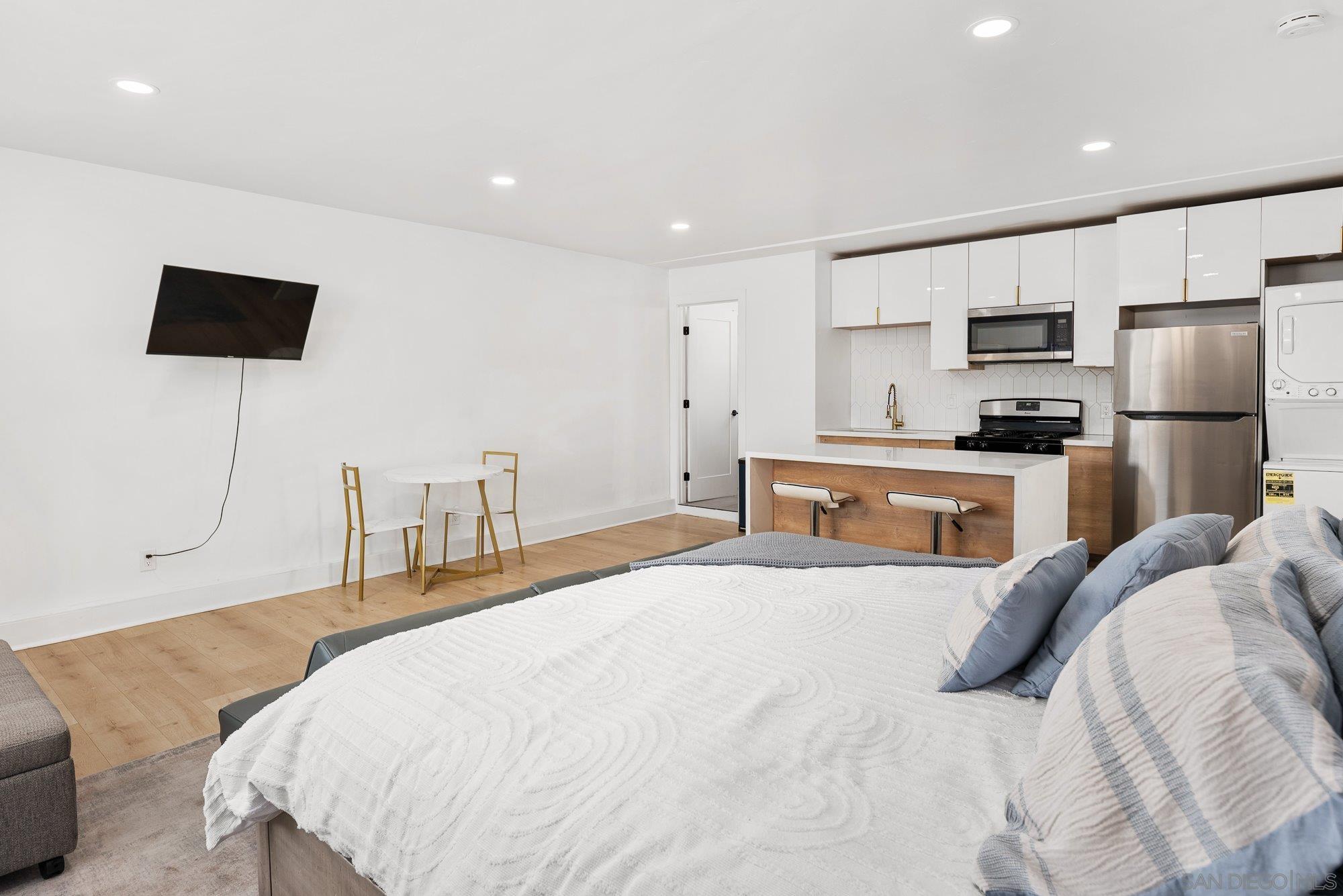 7942 Calico Street San Diego, CA 92126 - Photo 27 of 39 a bedroom with a bed and a television